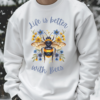 A white sweatshirt with the Life is Better with bees logo.